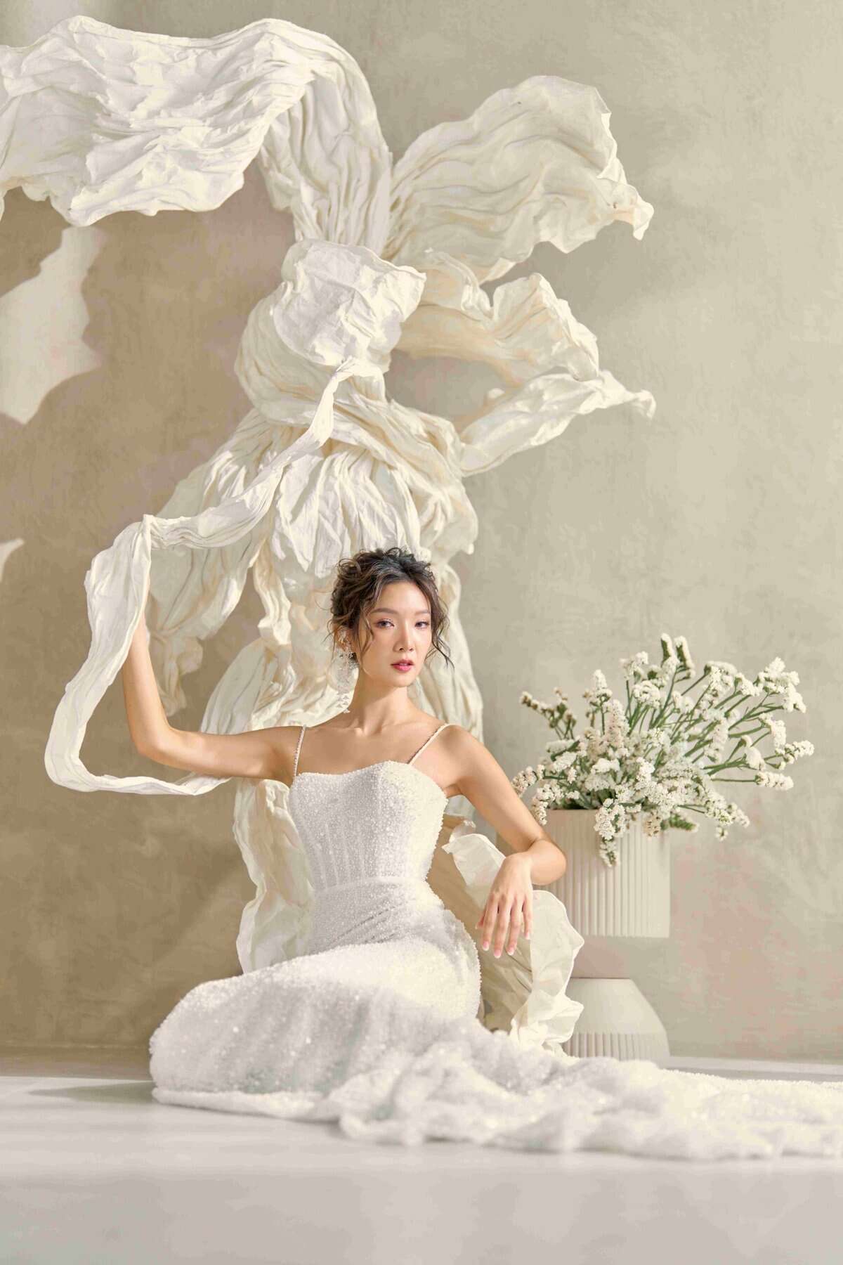 Elegant bridal gown with intricate lace details and a flowing silhouette, perfect for a luxurious wedding look.