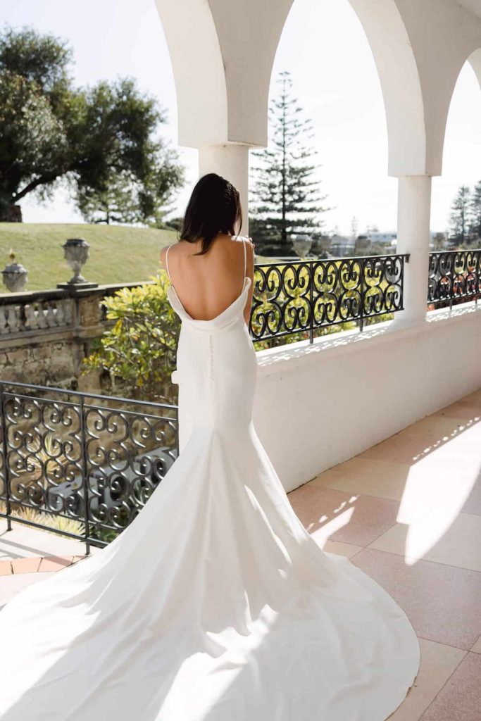 Low cowl back crepe mermaid wedding gown with long train by Cizzy Bridal