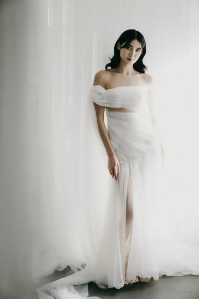 Hera off-the-shoulder draped tulle wedding gown with thigh slit