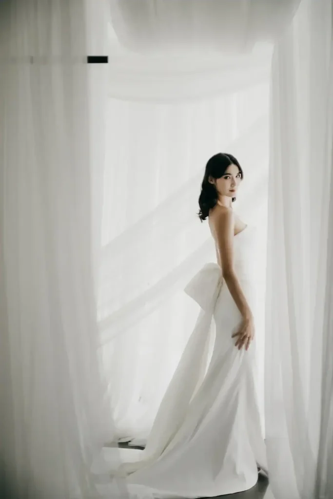 Hestia strapless crepe fitted wedding gown with oversized back bow and train