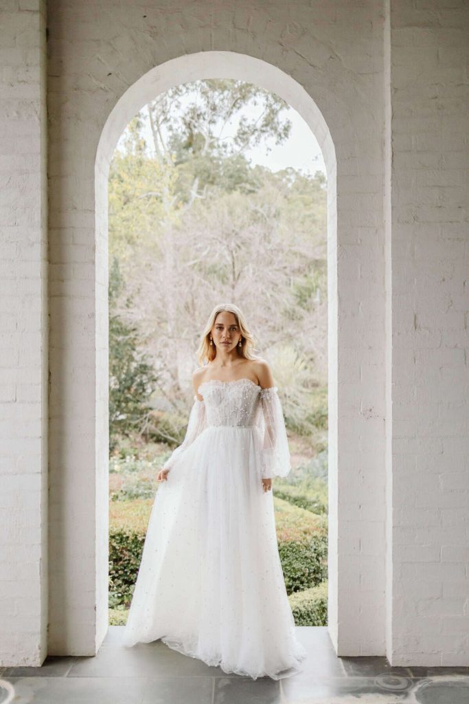 Strapless lace tulle gown with sheer balloon sleeves by Wedding Societe