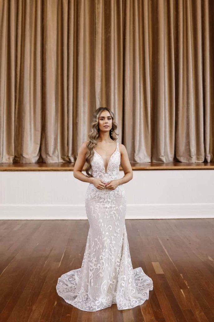 Plunging V-neck embroidered lace mermaid wedding gown by Zavana Bridal