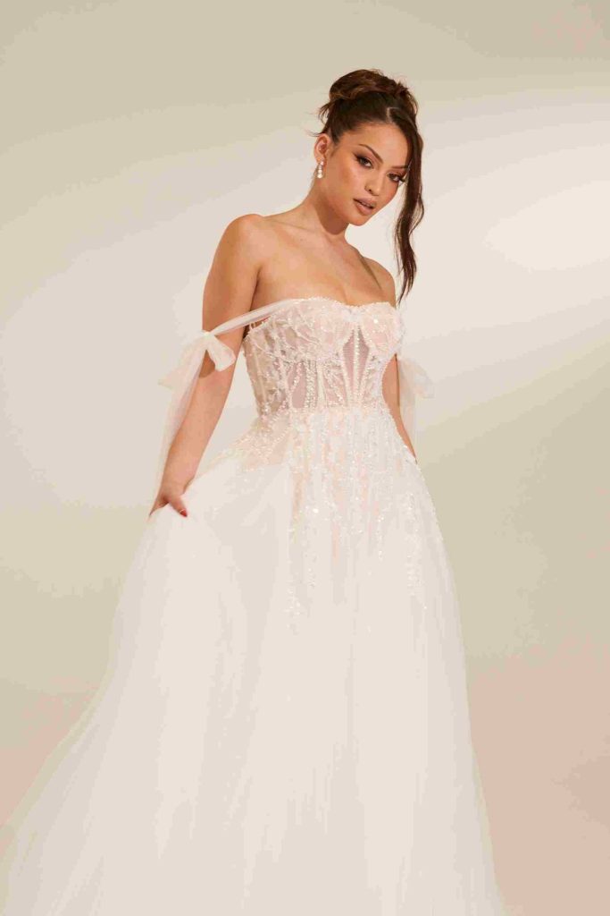 Sheer beaded corset tulle ball gown with tie shoulder straps by Zavana Bridal